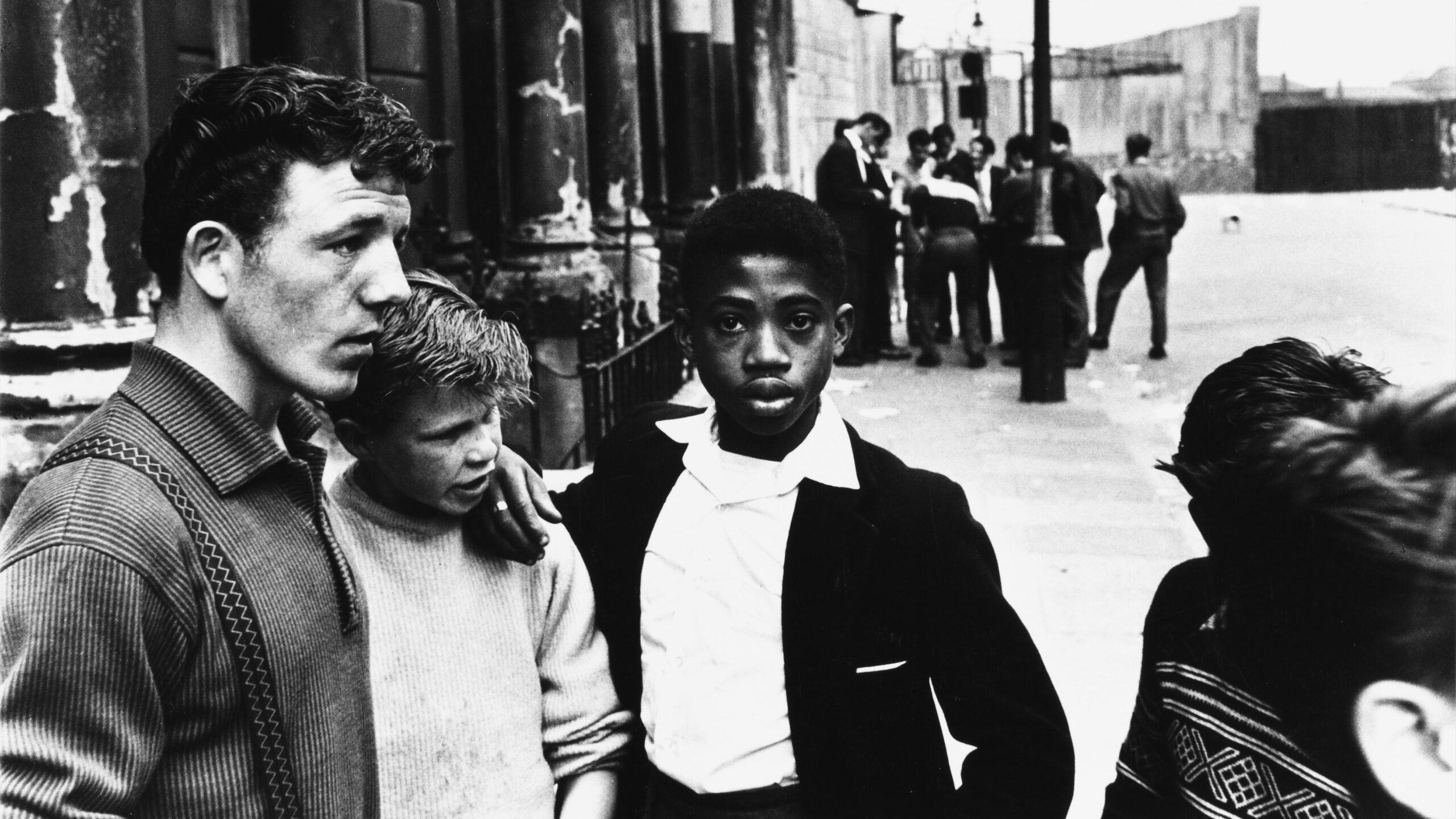 A black and white photo by Roger Mayne of teenage boys in 1950s inner city London