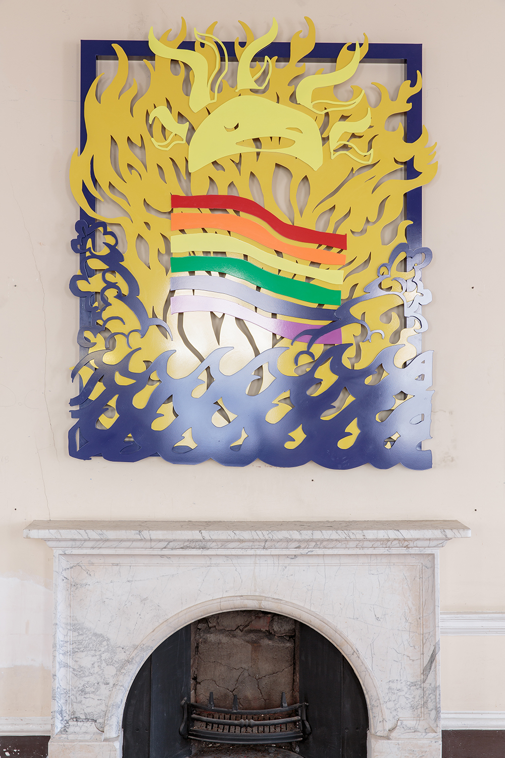 Installation view of UK Gay Bar Directory. The image shows an artwork on the wall above a fireplace, depicting smiling sun and a rainbow flag.