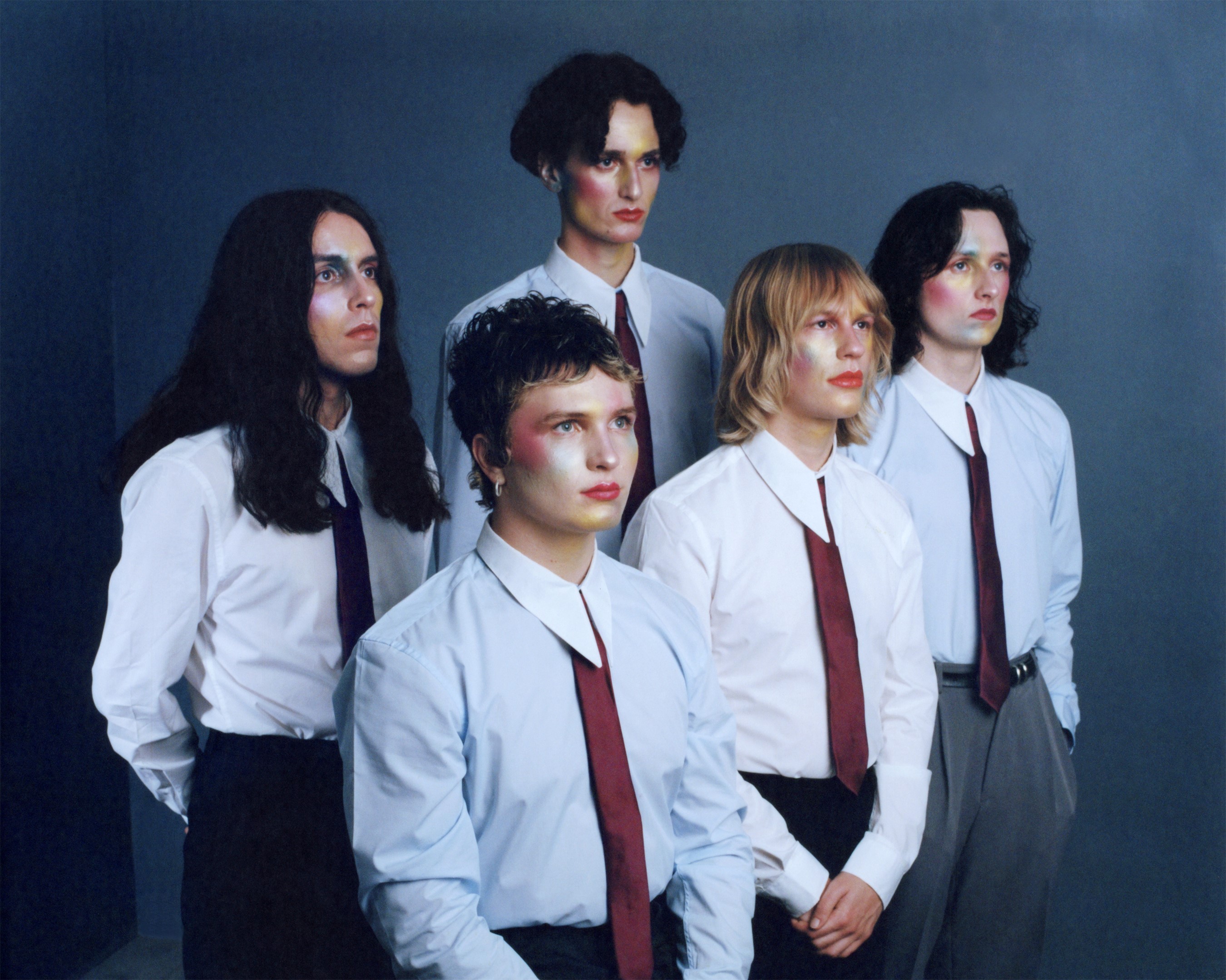 A portrait of the Glasgow band Walt Disco, a four-piece dressed in white shirts and ties