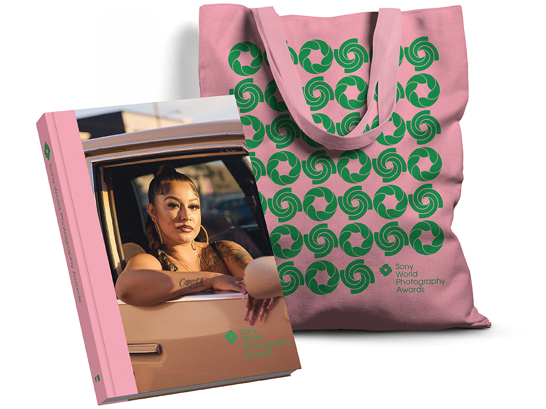 SWPA exhibition catalogue is placed in front of a pink and green tote bag.