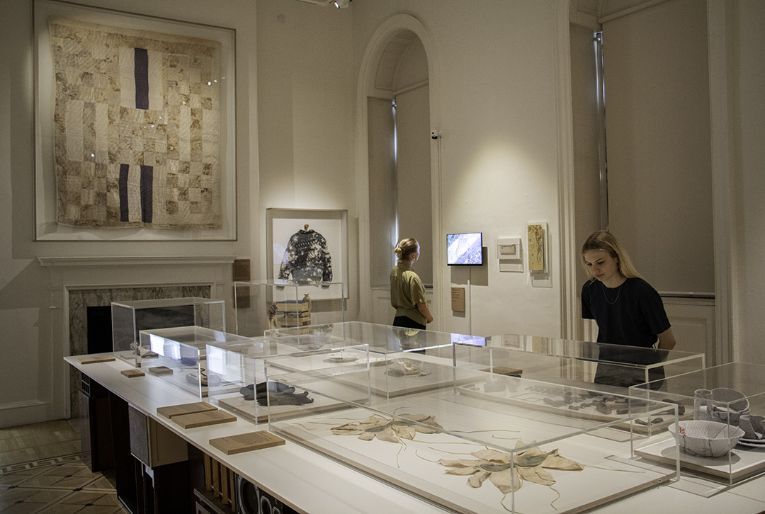 Exhibition installation view, people viewing artworks