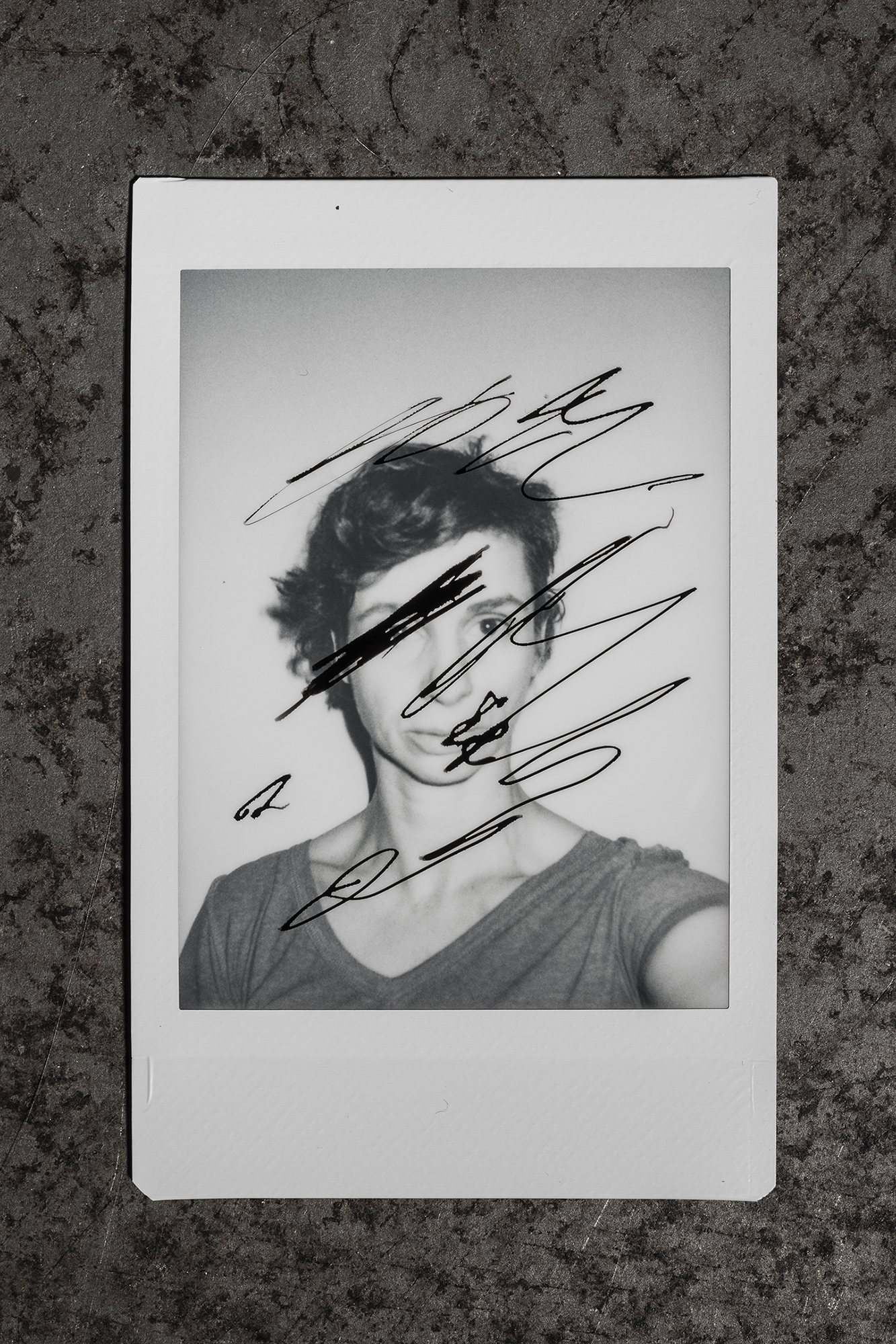 A polaroid of Sonya Stefan with artistic scribbles over her face and around her head