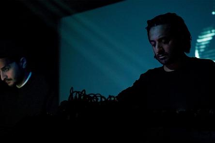 A photo of Paul Purgas and Imran Perretta performing together (as AMRA, their audiovisual collaboration)