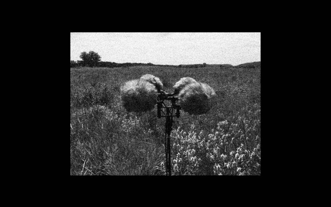A black and white photo of a field recording device in a field