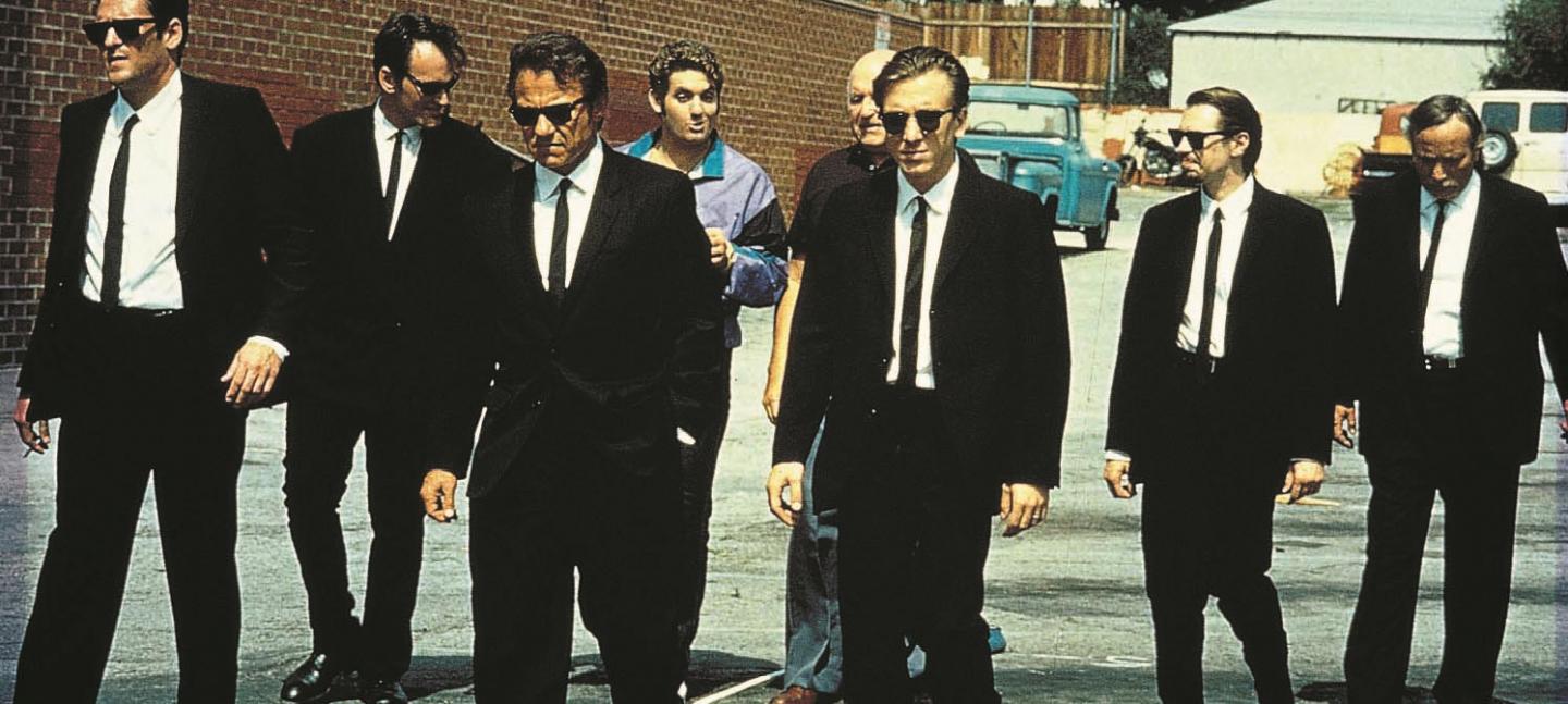 Film still of a group of men in suits