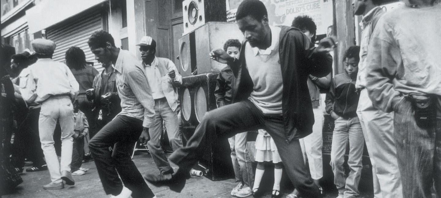 A group of men dancing in the street at Notting Hill Carnival