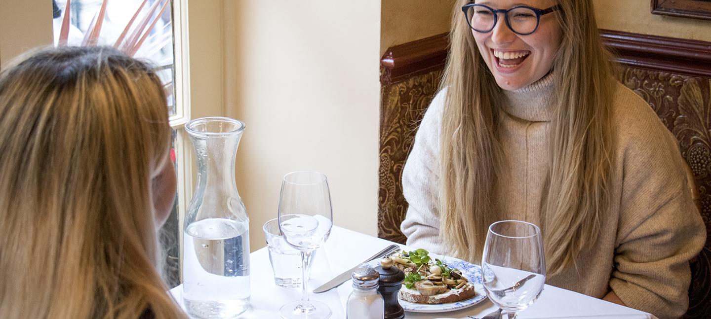 Woman laughing in Boulevard Brasserie restaurant