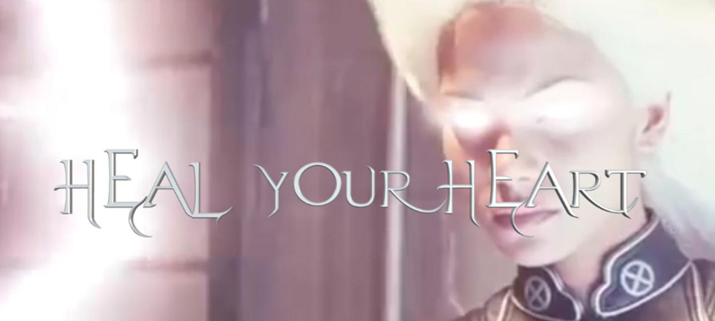 A picture of a face with white light in top right corner, with text over the top that says 'Heal your heart'