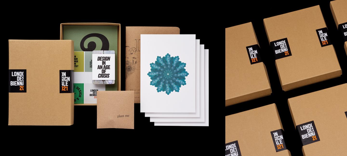 A photo of the souvenir box for London Design Biennale. It shows an art print, playing cards and some neatly placed packaging.