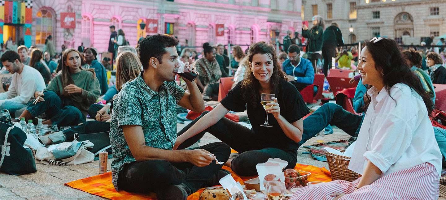 A photo of three young people enjoying themselves in the courtyard of Somerset House