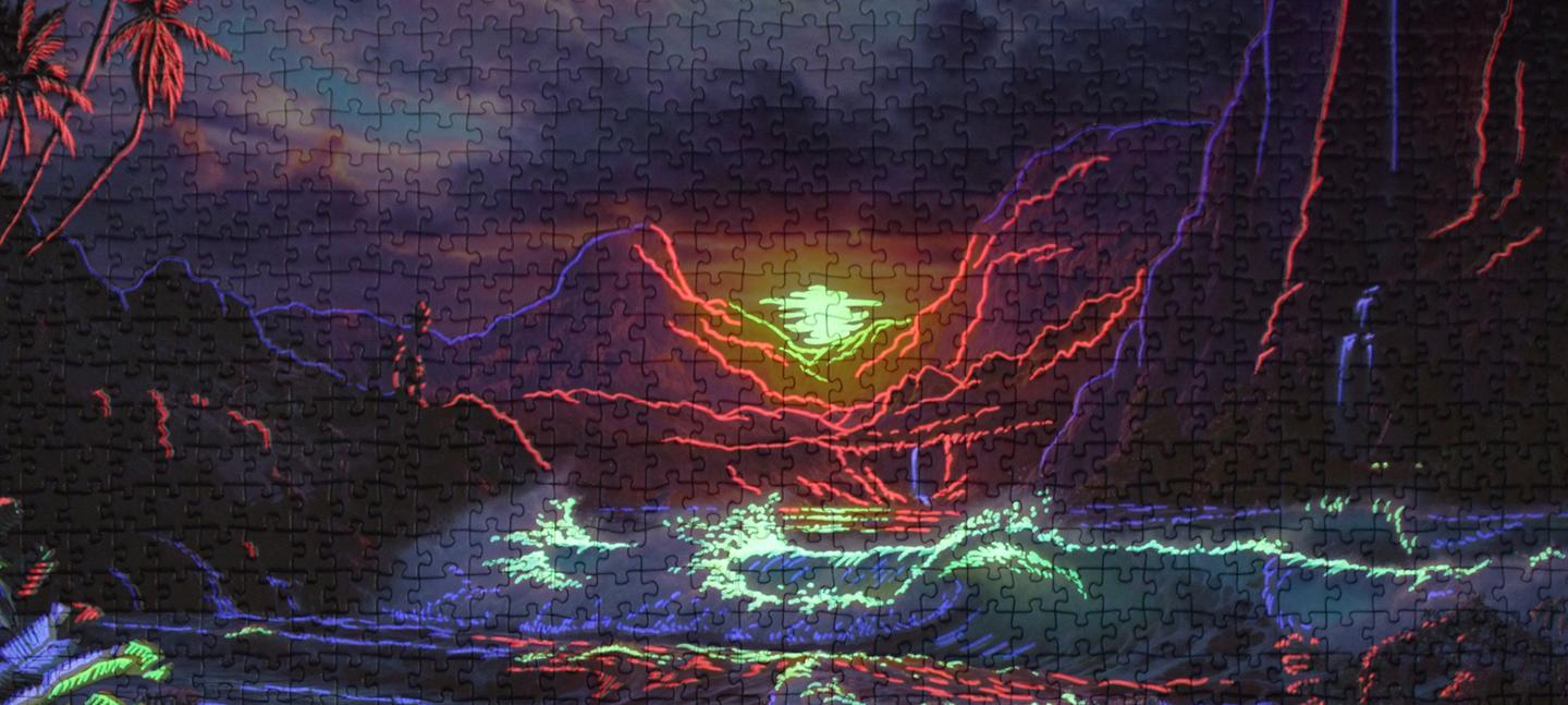 A photo of a kitsch jigsaw puzzle depicting waves, mountains and a setting sun in deep colours of blue, purple, pink.