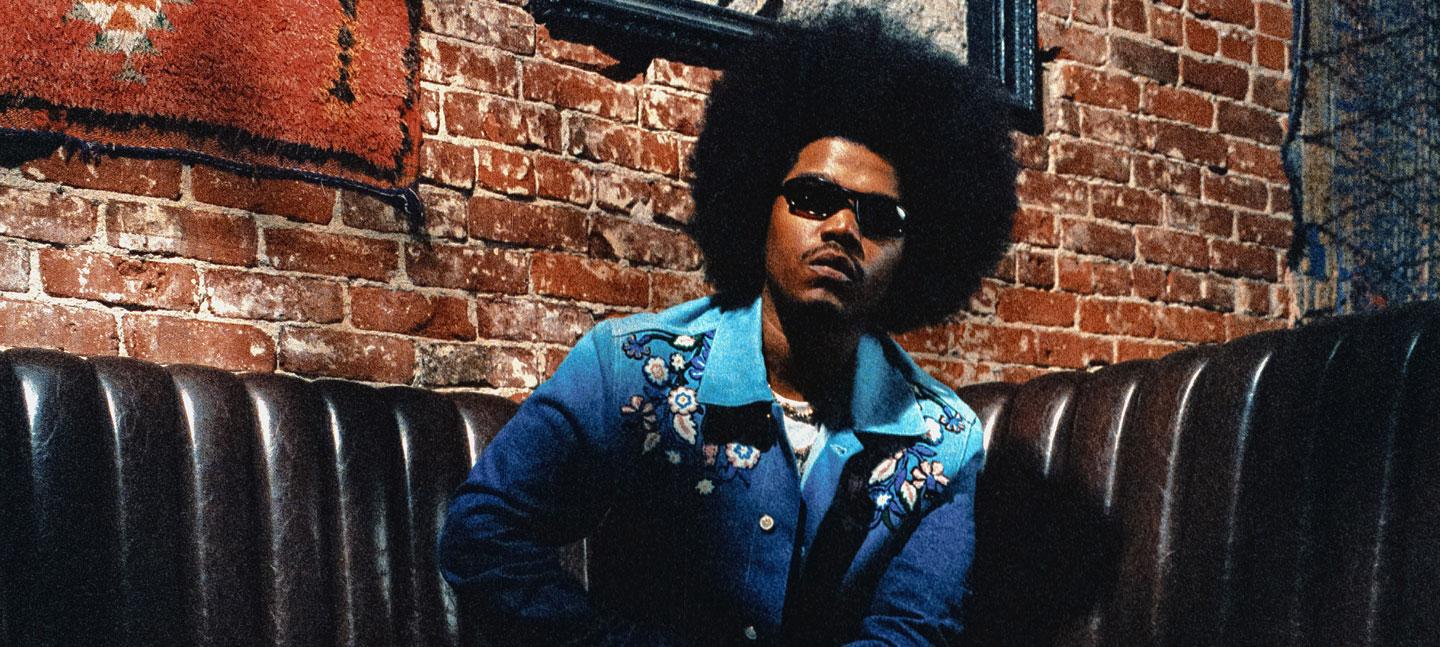 A photo of the US hip hop artist Smino wearing sunglasses