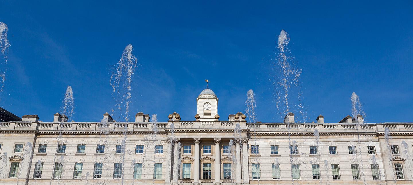 A photo of Somerset House against a backdrop of blue skies.