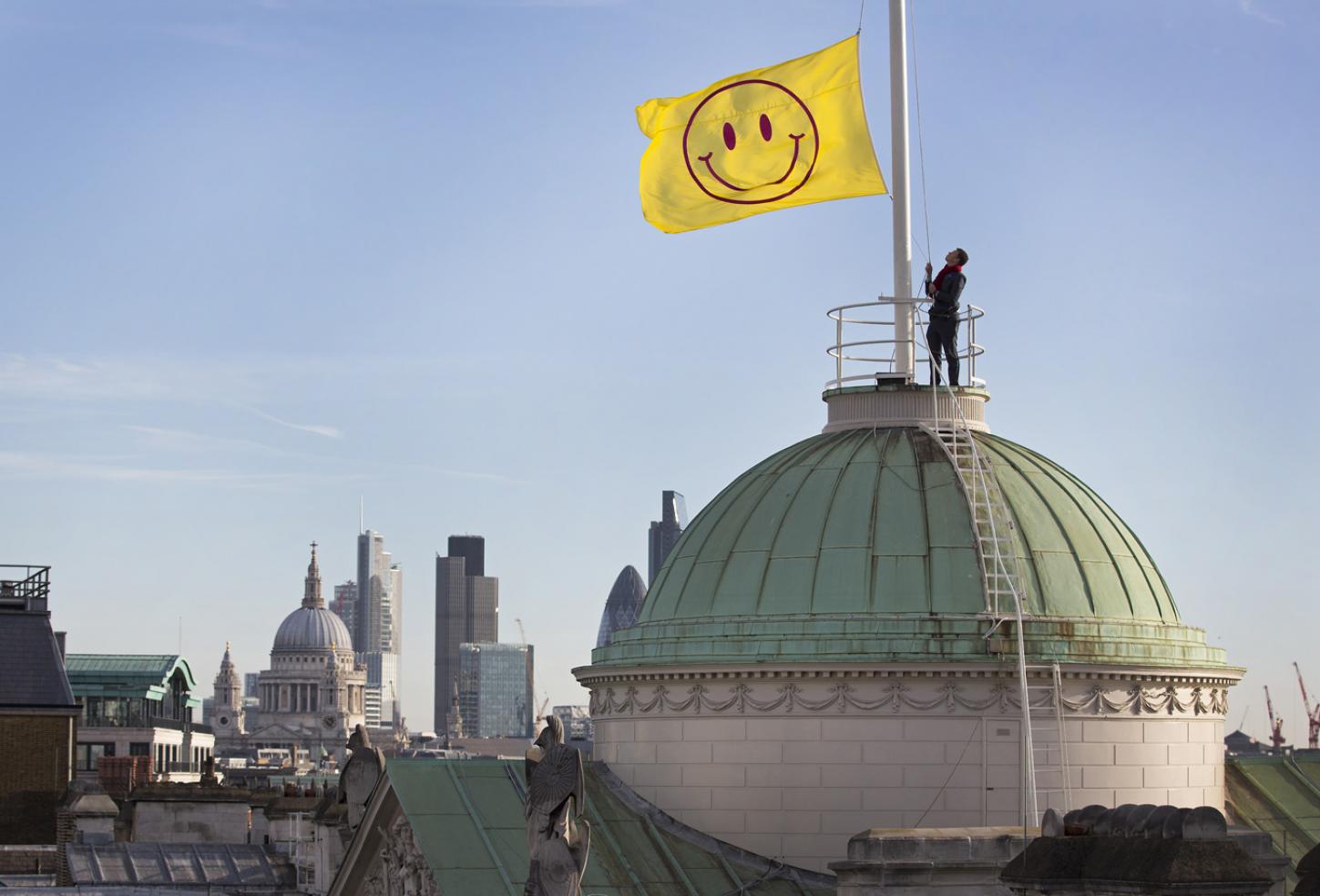 A flag designed by Jeremy Deller and Fraser Muggeridge studio is raised to the top of Somerset House as part of the launch of 'UTOPIA 2016 - A Year of Imagination and Possibility'