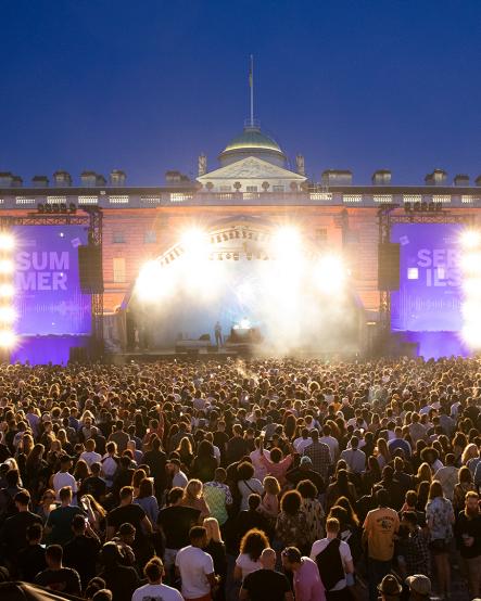 Crowd lit up by stage lights at Somerset House Summer Series with American Express