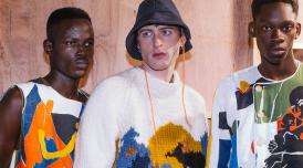 A photo of 3 men wearing patterned clothes at a fashion show, designed by Bethany Williams