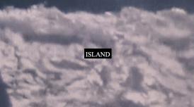 A still from Laura Grace Ford & Sam William's film ISLAND. It shows a fuzzy cloud-like substance with word ISLAND printed on it