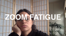 A photo of a woman looking bored while on a zoom call. There is text overlaid which reads 'ZOOM FATIGUE'
