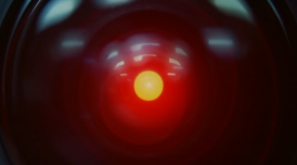 A still from 2001: A Space Odyssey, used as a reference for not/nowhere's episode of Transmissions. A close up of HAL. An ominous red light sits at the centre of a camera lens, unblinking.