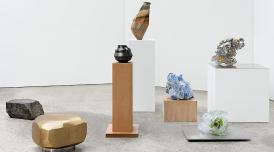 An installation view of some sculptures, presented on different height plinths in a white room.