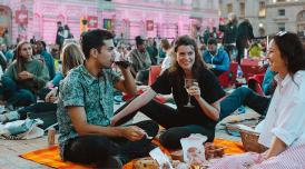 A photo of three young people enjoying themselves in the courtyard of Somerset House