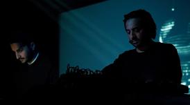 A photo of Paul Purgas and Imran Perretta performing together (as AMRA, their audiovisual collaboration)