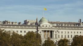 A photo of Somerset House courtyard at twilight, with fountains on.