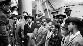 Jamaican immigrants being addressed shortly after their arrival in Tilbury by RAF officials from the Colonial Office in 1948. Photograph: PA