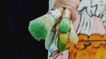 Person holding brushes