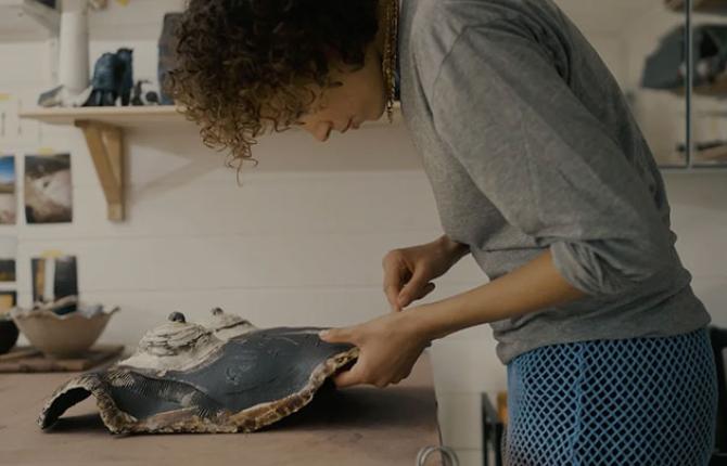 Artist Phoebe Collings James working on some ceramics